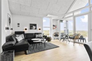 a living room with a black couch and a table at 793-Thisted-Havstokken-24-1 in Thisted +15 photos