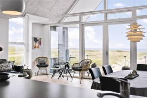 a living room with chairs and tables and windows at 793-Thisted-Havstokken-24-1 in Thisted