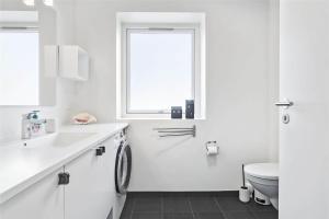 a white bathroom with a sink and a toilet at 793-Thisted-Havstokken-24-1 in Thisted