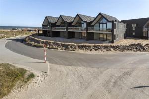 a house on the beach with a winding road at 793-Thisted-Havstokken-24-1 in Thisted