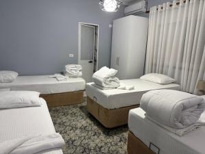 a room with four beds in a room at Villa CTT in Tirana +3 photos