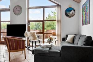 a living room with a couch and a tv at 490-Snedsted-Niels-Juels-Vej-39 in Snedsted
