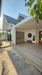a house with a large patio in front of it at No 5 Home in Ratchaburi
