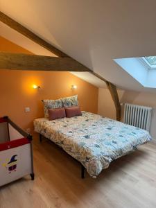 a bedroom with a bed in a attic at Au plaisir de l'ivoie in Le May-sur-Èvre
