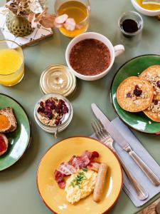 a table topped with plates of breakfast foods and drinks at Alfred Hotels Paris Gare du Nord- Hôtel Rénové in Paris