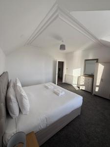 Casa Fresa - 31B High Street في Monifieth: غرفة نوم بسرير أبيض ومرآة +9 صور