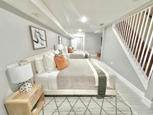 a bedroom with a large bed and a staircase at Dream Home Close to the Center of NYC in Mott Haven +37 photos