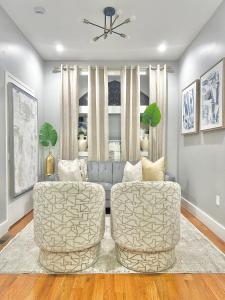 a living room with two chairs and a couch at Dream Home Close to the Center of NYC in Mott Haven