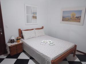 Ένα ή περισσότερα κρεβάτια σε δωμάτιο στο Pousada Terra do Ipê