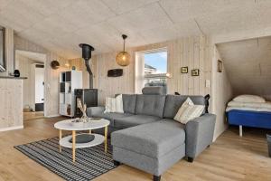 a living room with a couch and a table at 1059-Klitmoller-Mollebakken-56 in Klitmøller