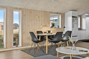 a kitchen with a table and chairs in a room at 1059-Klitmoller-Mollebakken-56 in Klitmøller