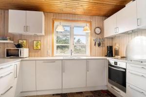 a kitchen with white cabinets and a window at 930-Thisted-Liusborg-Sti-28 in Torsted +10 photos