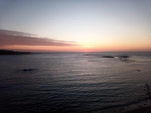 a sunset over a large body of water at Playas de Quintero in Quintero +3 photos