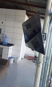 a computer monitor hanging on a wall in a room at Casa em Itapucu SC a 200mts do trapiche in Araquari