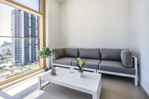 a living room with a couch and a table at Intempo by Holuxe - 034 - 3rd floor in Benidorm