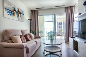 a living room with a couch and a table at Intempo by Holuxe - 034 - 3rd floor in Benidorm