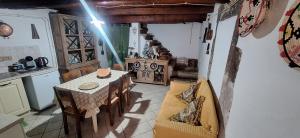 a kitchen and dining room with a table and chairs at B&B Montiju in Ozieri +11 photos