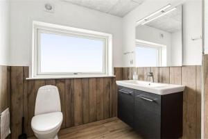 une salle de bains avec toilettes, lavabo et miroir dans l'établissement 899-Snedsted-Somaerkevej-76-B, à Snedsted 11 autres photos