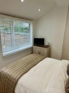 a bedroom with a large bed and a window at Kettering Railway Lodge in Northamtonshire +5 photos