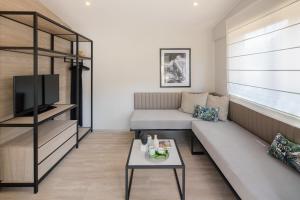 a living room with a couch and a table at Gava Waterman Milna Resort – All Inclusive in Milna