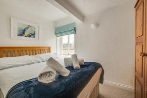 a bedroom with a bed with towels on it at 1 Bed in St. Ives oc-pc466a in St Ives