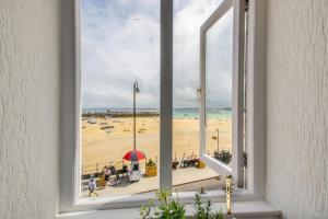 a view of a beach from a window at 1 Bed in St. Ives oc-pc466a in St Ives