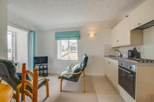 a kitchen with two chairs and a table and a dining room at 1 Bed in St. Ives oc-pc466a in St Ives +3 photos