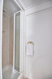 a white bathroom with a towel hanging on a wall at 1 Bed in St. Ives oc-pc466a in St Ives