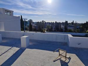 a chair sitting on the roof of a house at App corniche hammamet in Hammamet