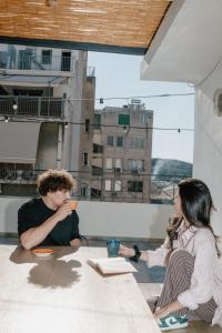 a man and a woman sitting at a table at Next door Athens in Athens +56 photos