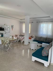 a living room with a couch and a table at App corniche hammamet in Hammamet +16 photos
