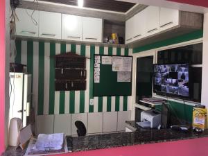 an office with a green and white striped wall at Hotel Maracá in Boa Vista
