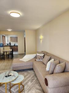 a living room with a couch and a table at Casaroca Stylish 2br in Nakuru