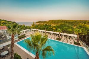 an aerial view of a resort with a pool and chairs at Gava Waterman Milna Resort – All Inclusive in Milna
