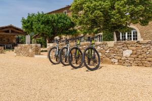 a row of bikes parked next to a stone wall at Gite Monet in Bouchet
