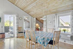 a dining room with a table and chairs at 1052-Thisted-Bavnbak-50 in Torsted