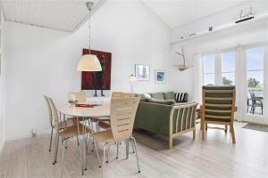 a kitchen and dining room with a table and a couch at 266-Vestervig-Havnevej-1-lejl-19 in Vestervig
