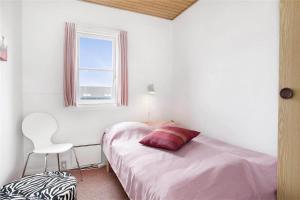 a bedroom with a bed with a red pillow on it at 266-Vestervig-Havnevej-1-lejl-19 in Vestervig +27 photos
