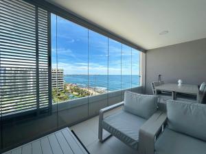 a living room with a view of the ocean at Luxury Sea View - PANORAMA MAR- PUNTA PRIMA by GrupoQuattro in Punta Prima