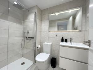 a bathroom with a shower and a toilet and a sink at Luxury Sea View - PANORAMA MAR- PUNTA PRIMA by GrupoQuattro in Punta Prima +22 photos