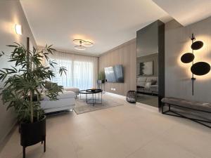 a living room with a white couch and a table at Luxury Sea View - PANORAMA MAR- PUNTA PRIMA by GrupoQuattro in Punta Prima