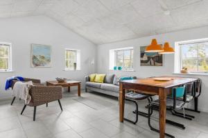 a living room with a table and a couch at 459-Snedsted-Istrupvej-48 in Snedsted