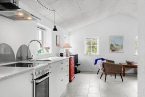 a kitchen with a sink and a stove top oven at 459-Snedsted-Istrupvej-48 in Snedsted