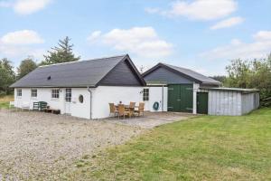 a white house with a table and chairs at 459-Snedsted-Istrupvej-48 in Snedsted