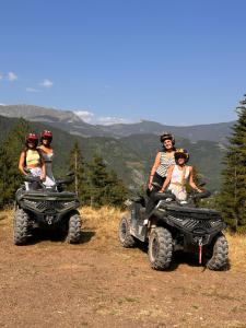 a group of people riding on atvs on a mountain at Hotel Te Liqeni in Peje +84 photos
