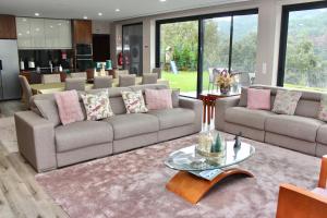 a living room with two couches and a table at Villa Recanto de Fornelos, Gerês - Até 10 Pax in Geres