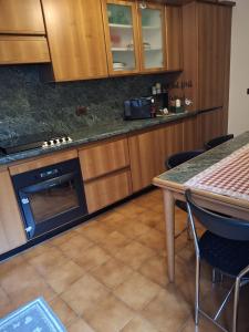 a kitchen with a counter and a table with chairs at Il Borgo By Phoenix in Olmo al Brembo +14 photos