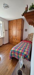 a bedroom with a bed and a wooden cabinet at Il Borgo By Phoenix in Olmo al Brembo