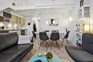 a living room with a couch and a table and chairs at 254-Vestervig-Havnevej-1-lejl-4 in Vestervig