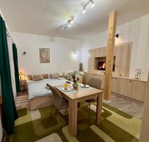 a room with a bed and a table with chairs at Infinity Apartman in Esztergom